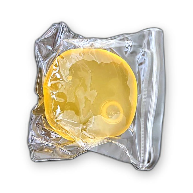 Yellow Squishlotte Original Squishy in its clear bag.